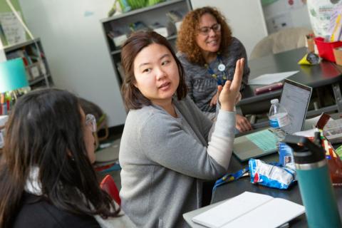 A kindergarten teacher shares her lesson ideas during a team planning session.